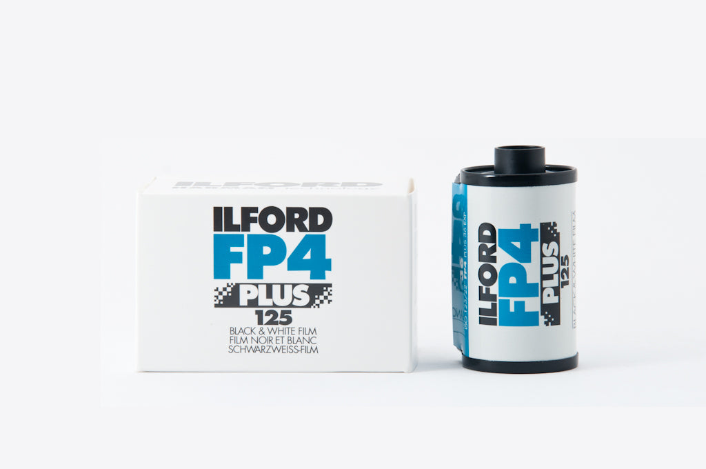 Ilford FP4 Plus 125 film canister and packaging on a white background